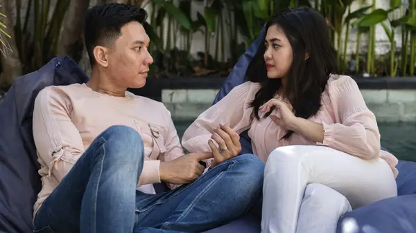 couple on couch debating