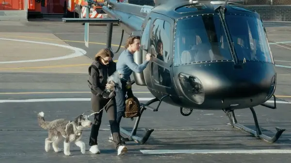 Ana de Armas with Tom Cruise next to a helicopter