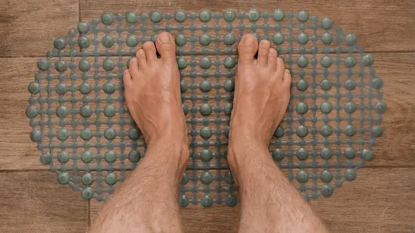 Feet on shower mat