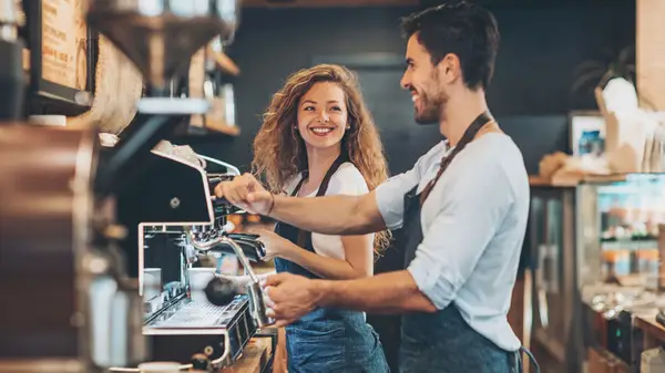Barista coworkers flirter