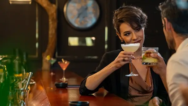 woman and man flirting at bar