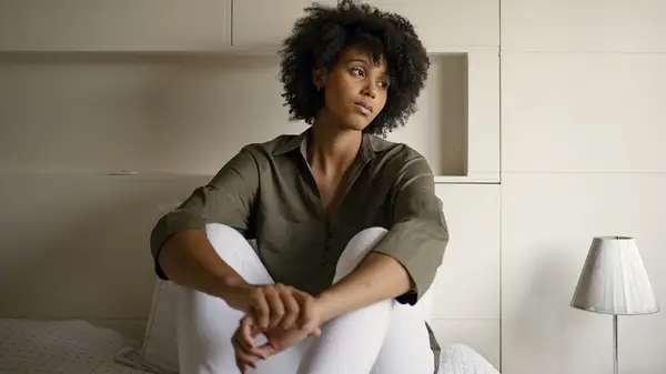 woman on bed thinking