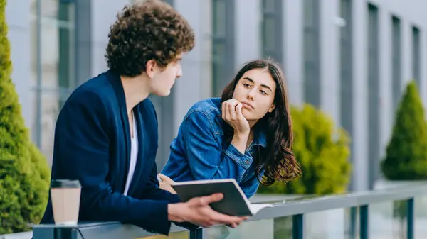 man and woman talking outside
