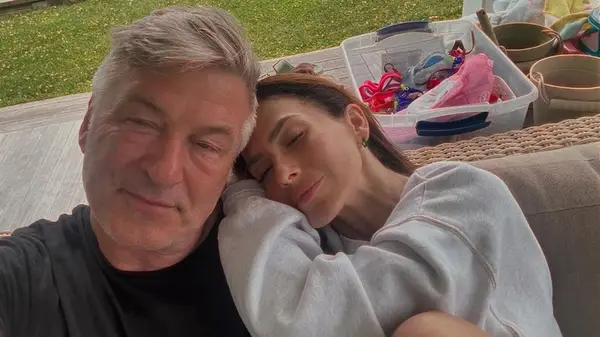 Hilaria Baldwin resting on Alec Baldwin