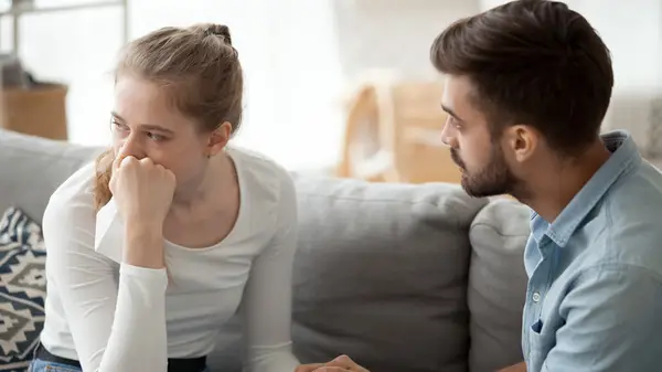 Man comforting upset woman
