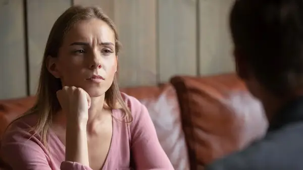 An unhappy looking woman on a date 