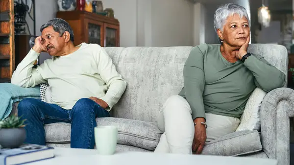 Elderly man and woman sitting on a couch
