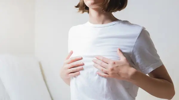 woman holding her breasts