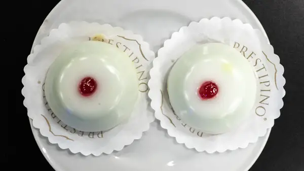 two breast-looking cakes