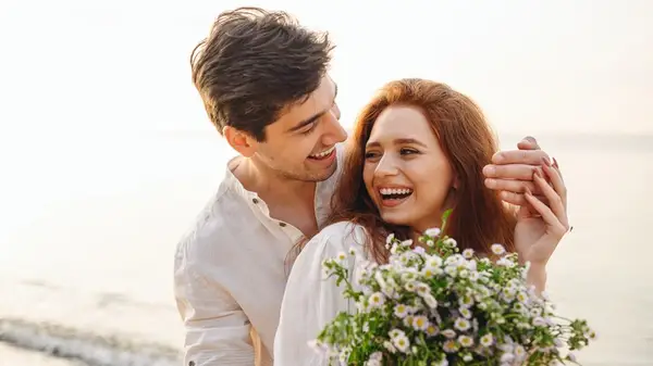 A couple posing with flowers