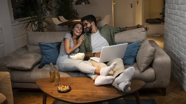 couple watching movie on laptop
