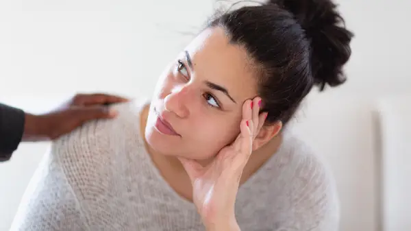 woman being consoled by friend