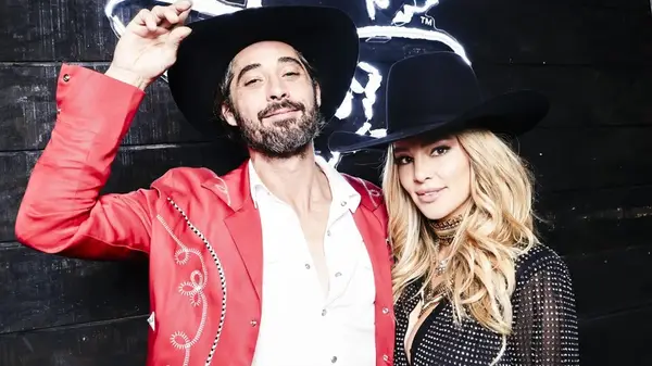 Hassie Harrison and Ryan Bingham posing together in cowboy hats