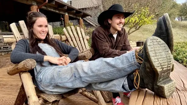 Eden Brolin and Cameron Crosby sitting together in Adirondack chairs, smiling