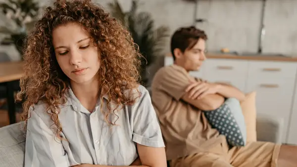man and woman angry on couch