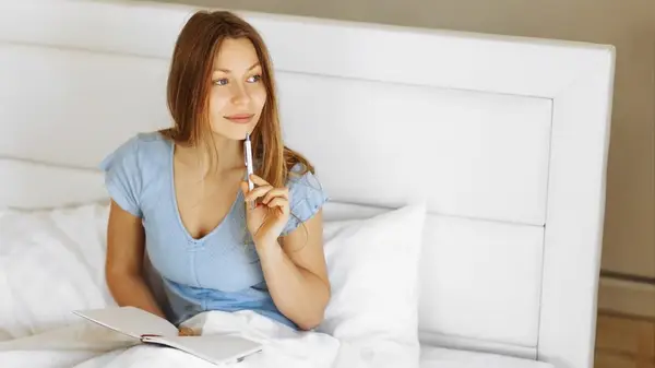 Woman writing in gratitude journal