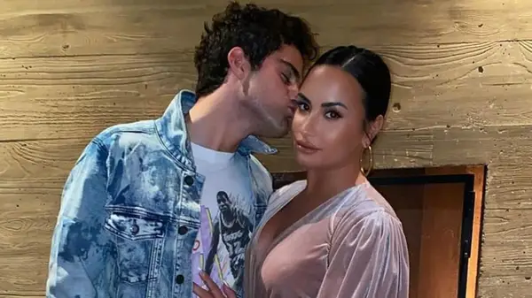 Max Ehrich kissing Demi Lovato on the cheek