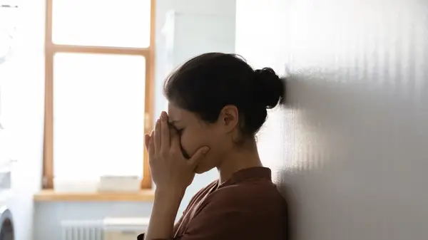 Woman crying into her hands