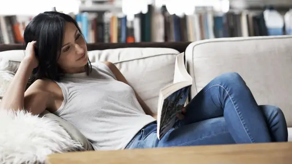 woman reading on couch