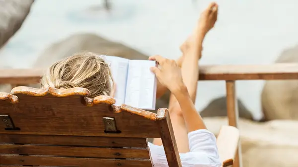 Woman reading book outdoors