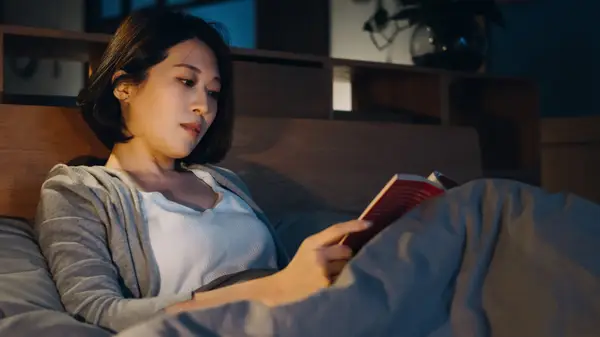 Woman reading in bed