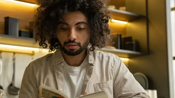 Bearded person reading