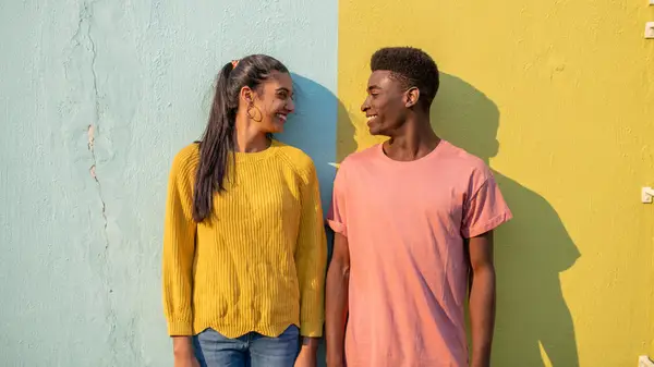 Couple standing by wall