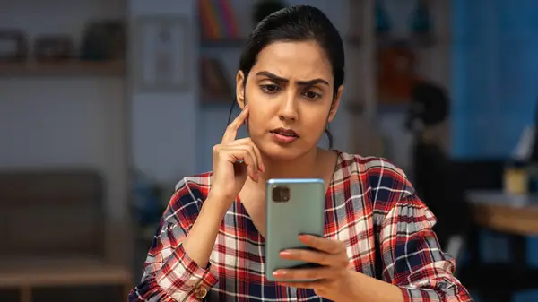 woman staring at smartphone