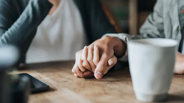 Holding hands at cafe