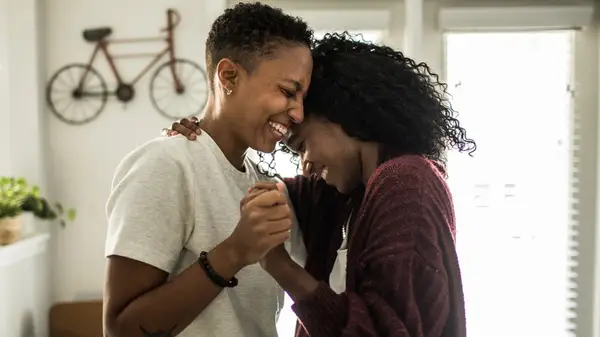 Two women smiling and dancing