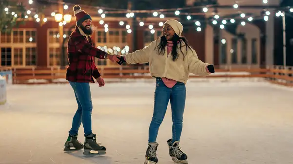 Couple ice skating together