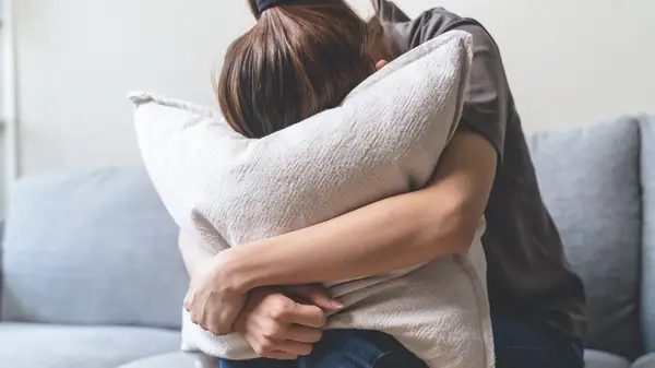 girl with head in pillow 