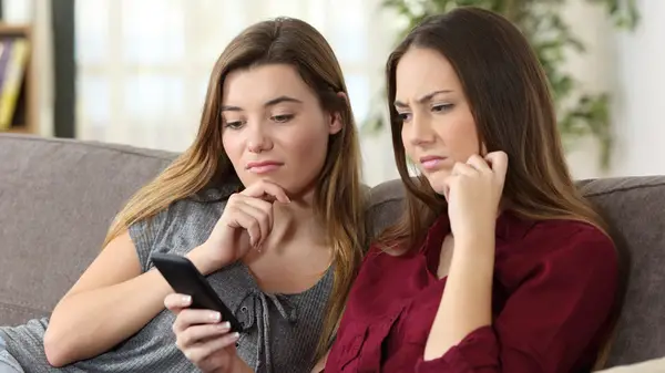 two women looking at phone
