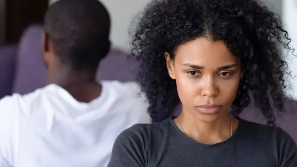 Woman with back to partner