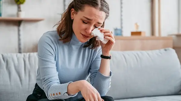 Woman wiping tears