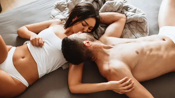 Couple kissing in bed