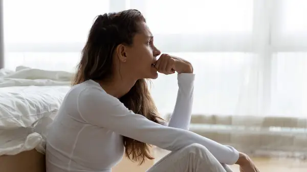 woman self-reflecting biting nails