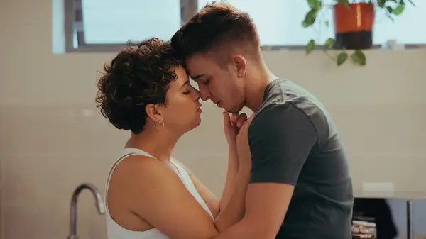 A couple embracing face to face