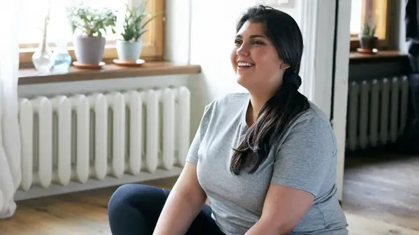 Woman smiling sitting on floor