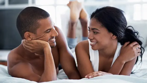 Couple talking in bed