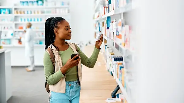 Woman looks at vitamin supplements