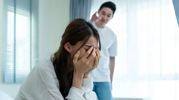 Man pointing at woman