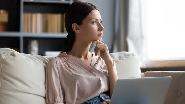 Woman looking sad, hand on chin
