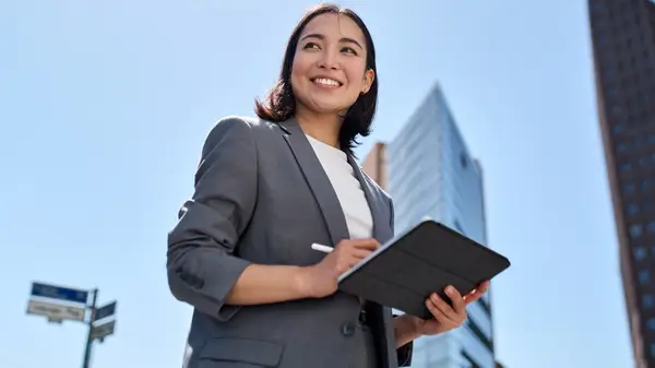 smiling woman on tablet