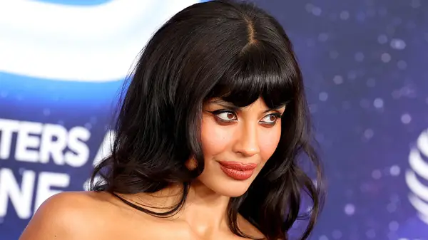 Slanted, close-up photo of Jameela Jamil on the red carpet, with smoky eyes and nude lipstick