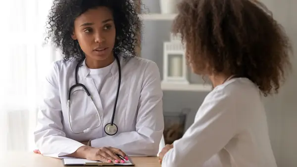 Woman consulting with doctor