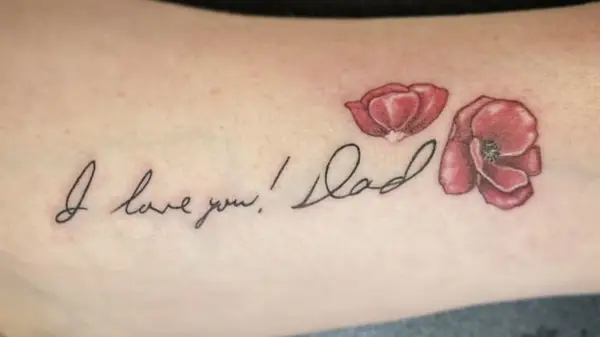 Photo of tattoo of hand-written script and flowers