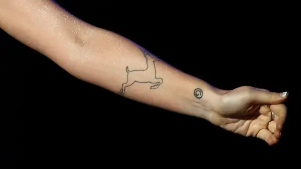 outline of a deer tattooed on woman