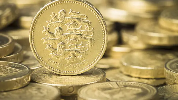 a pile of British one pound coins