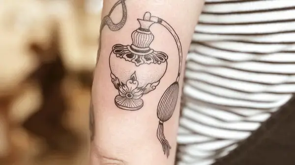 tattoo of perfume bottle on a woman